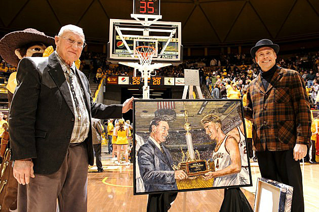 Kenny Sailors poses with a painting from the University of Wyoming's 1943 NCAA Championship. Courtesy of UW Photo Service.